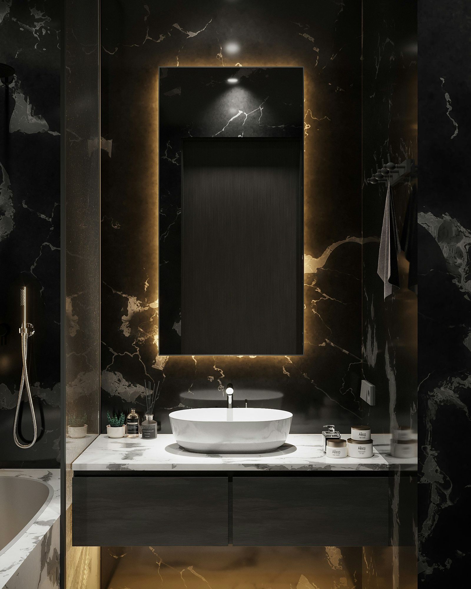 A black marble vanity with a backlit mirror